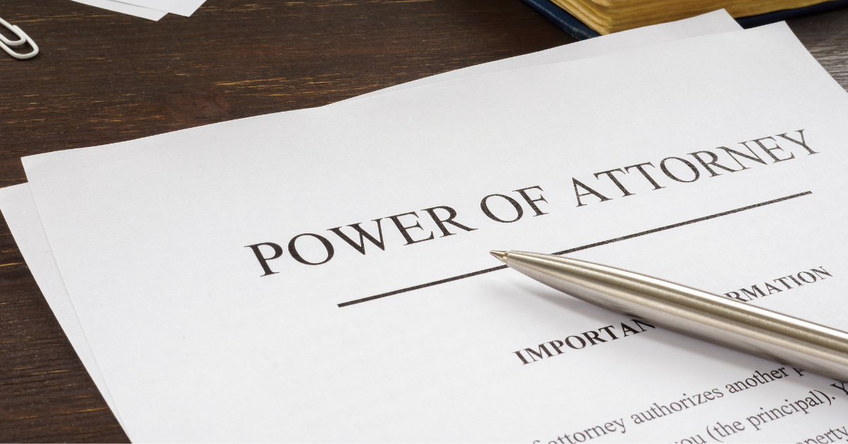 Paper with text "power of attorney" and pen
