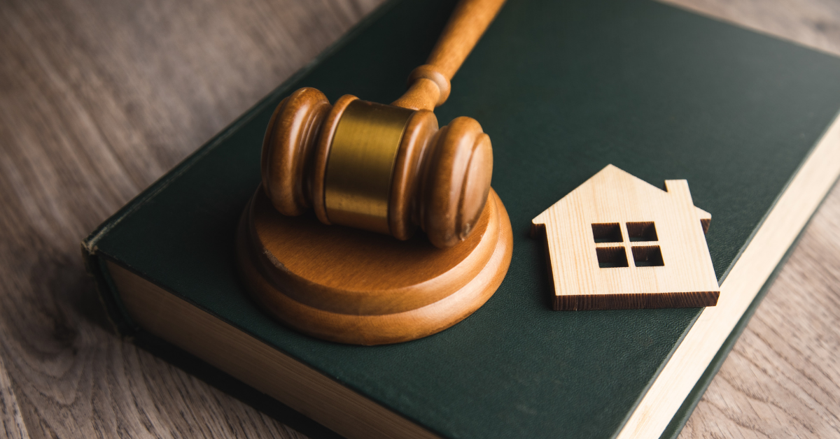 Gavel and house on top of book